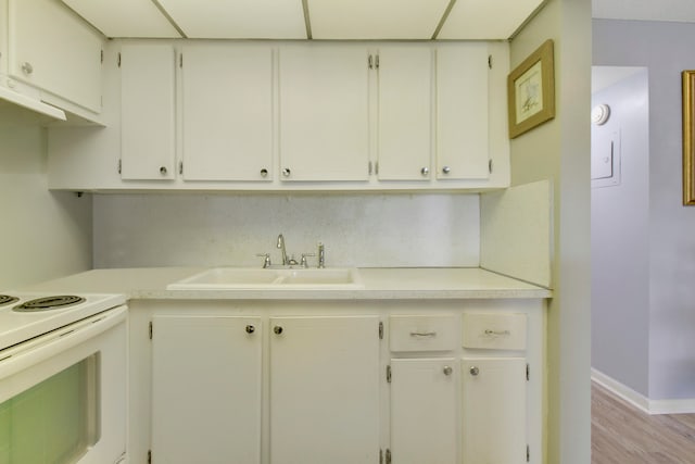 kitchen featuring white cabinets, light hardwood / wood-style floors, sink, and white electric stove