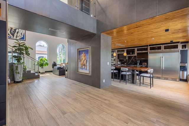 interior space featuring hardwood / wood-style floors and a towering ceiling