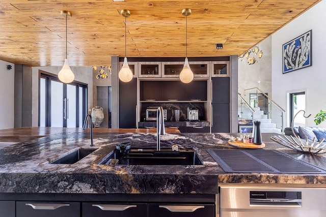 kitchen featuring pendant lighting, wood ceiling, and sink