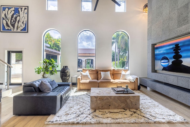 living room with a high ceiling and light wood-type flooring