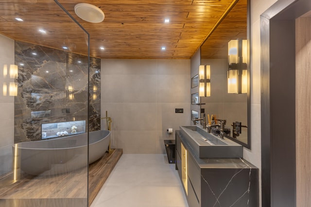 bathroom featuring a tub to relax in, vanity, wood ceiling, and tile walls