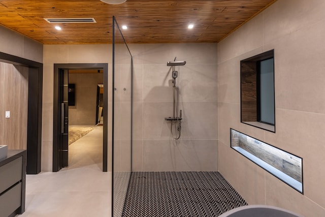 bathroom with vanity, wood ceiling, tile walls, and walk in shower