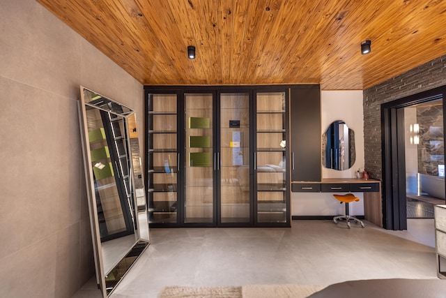 interior space featuring concrete floors and wood ceiling