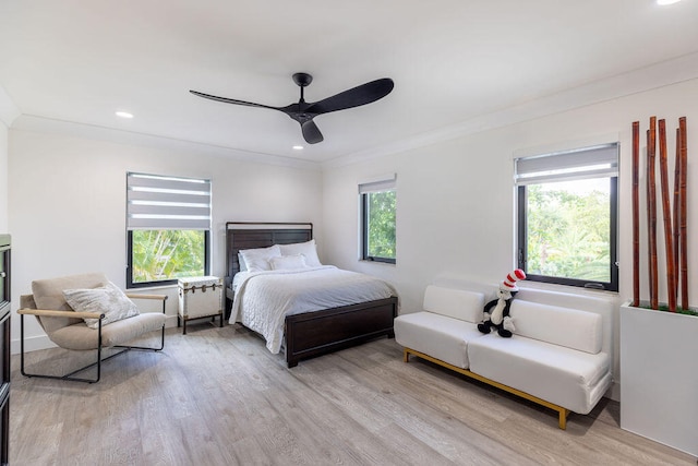 bedroom featuring multiple windows, ceiling fan, and light wood-type flooring