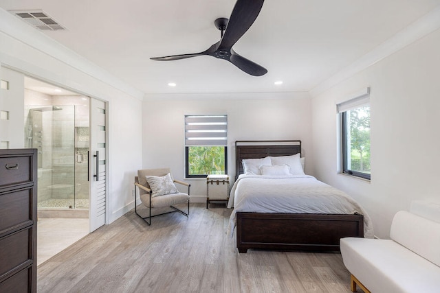 bedroom with ensuite bath, ceiling fan, light hardwood / wood-style flooring, and ornamental molding