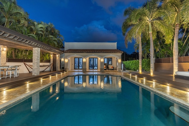 view of swimming pool with an outbuilding and a patio