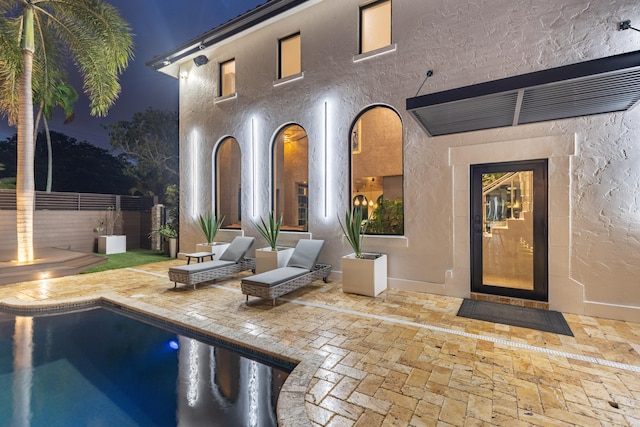 exterior space featuring a fenced in pool and a patio area