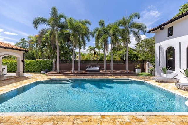 view of pool featuring a deck and a patio area