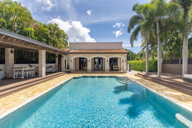 view of swimming pool with a patio area and an outbuilding