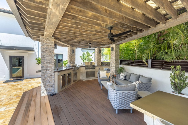 wooden terrace featuring outdoor lounge area, area for grilling, ceiling fan, and a grill