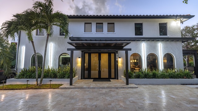 back house at dusk with french doors