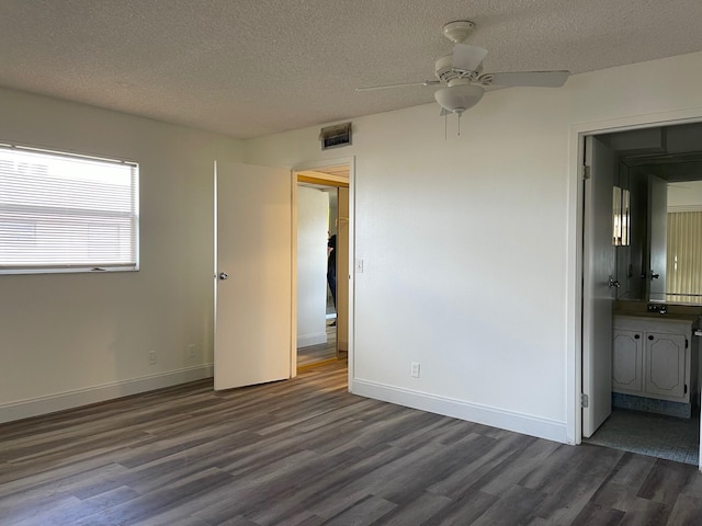 spare room featuring ceiling fan, dark hardwood / wood-style flooring, and a textured ceiling