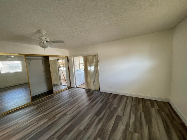 interior space featuring ceiling fan, a closet, dark hardwood / wood-style floors, washer / clothes dryer, and a textured ceiling