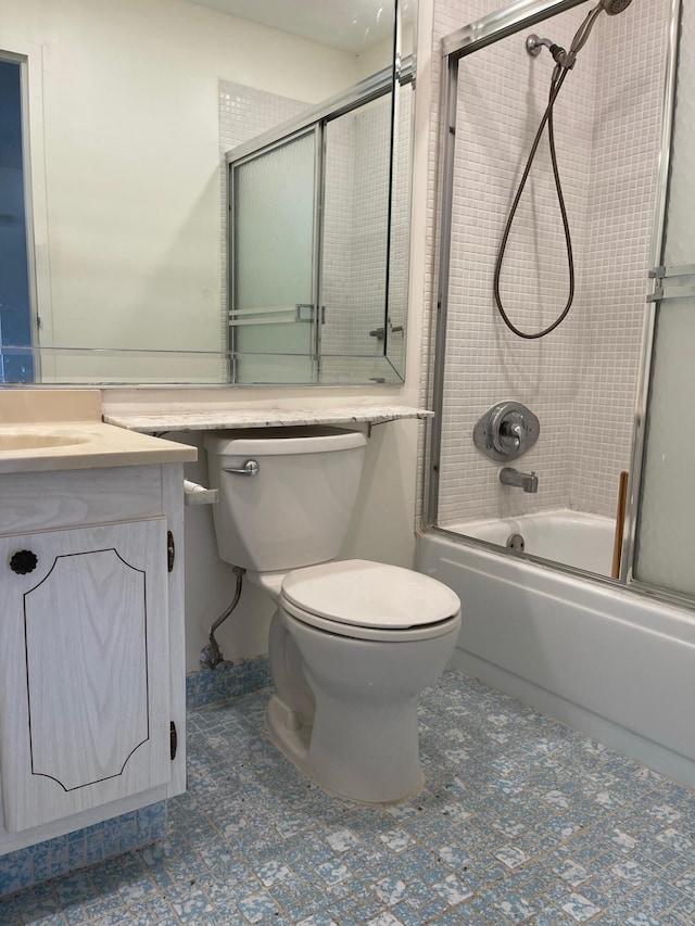 full bathroom with shower / bath combination with glass door, vanity, and toilet