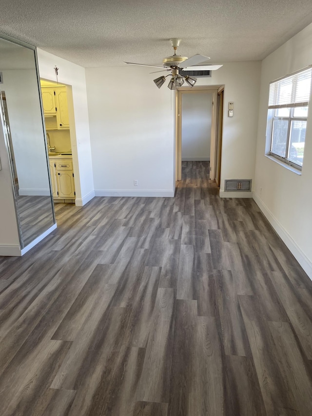 34 Brittany Unit A, Delray Beach, FL 33446 - interior space with baseboards, a textured ceiling, ceiling fan, and dark wood-style floors