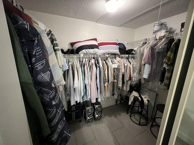 walk in closet featuring tile patterned flooring