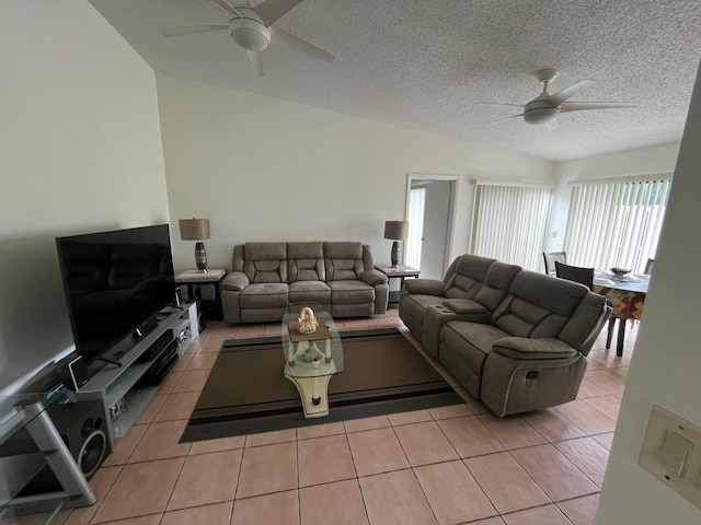 tiled living room with a textured ceiling and ceiling fan