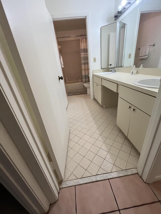 full bathroom with tile patterned flooring, shower / bath combo, vanity, and toilet