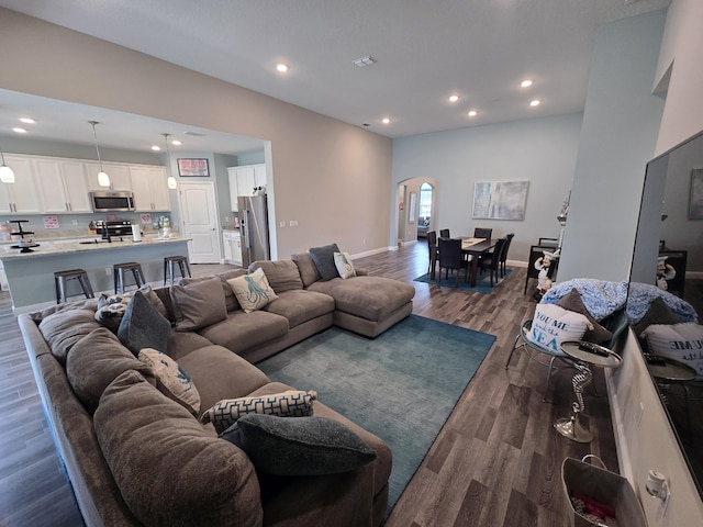 1892 SW Altman Ave, Port Saint Lucie, FL 34953 - living room with recessed lighting, arched walkways, baseboards, and dark wood finished floors