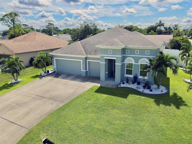 view of front of home with a front yard and a garage