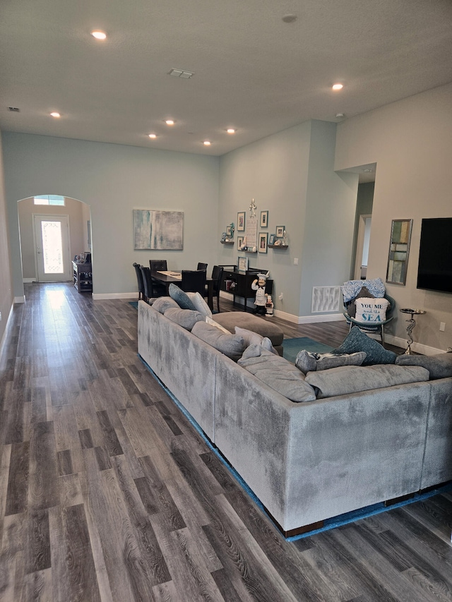 1892 SW Altman Ave, Port Saint Lucie, FL 34953 - living area with visible vents, baseboards, recessed lighting, arched walkways, and dark wood finished floors
