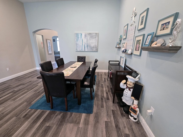 1892 SW Altman Ave, Port Saint Lucie, FL 34953 - dining space featuring arched walkways, baseboards, and wood finished floors