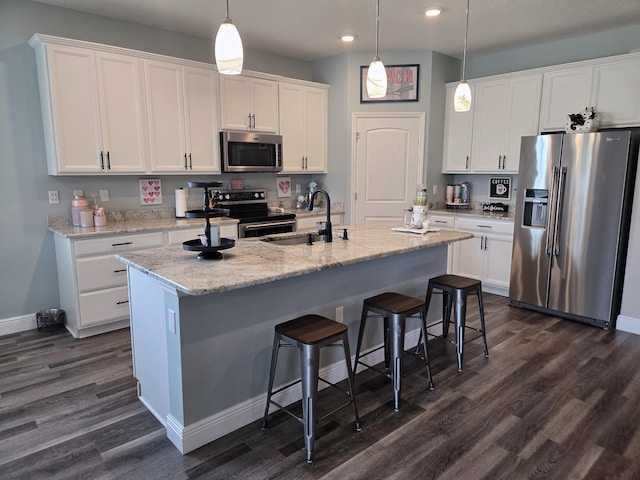 1892 SW Altman Ave, Port Saint Lucie, FL 34953 - kitchen with dark wood-style floors, recessed lighting, white cabinetry, a sink, and appliances with stainless steel finishes