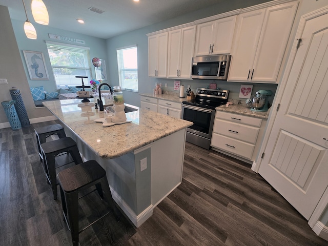 1892 SW Altman Ave, Port Saint Lucie, FL 34953 - kitchen featuring white cabinets, dark wood-style flooring, a sink, stainless steel appliances, and visible vents