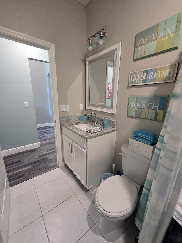 bathroom featuring hardwood / wood-style floors, vanity, and toilet