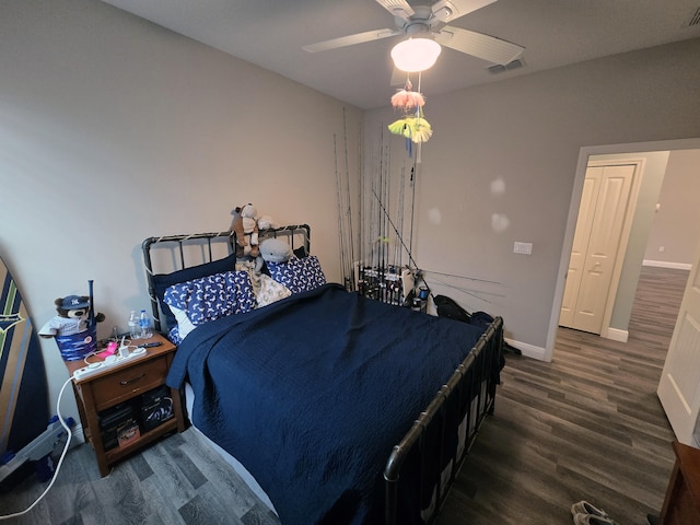 bedroom with dark wood-type flooring and ceiling fan