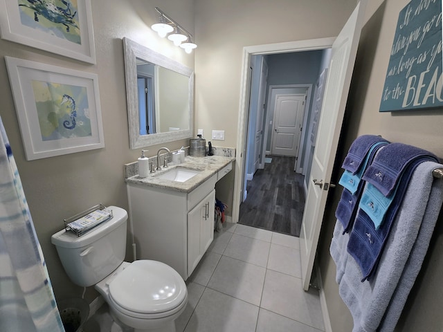 1892 SW Altman Ave, Port Saint Lucie, FL 34953 - bathroom featuring toilet, baseboards, tile patterned flooring, and vanity