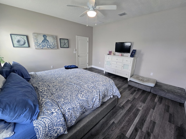 bedroom with dark hardwood / wood-style flooring, a textured ceiling, and ceiling fan