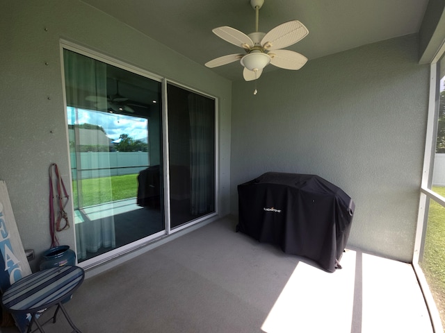 sunroom / solarium featuring ceiling fan