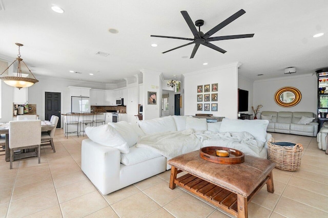 living room featuring crown molding, light tile patterned floors, and ceiling fan