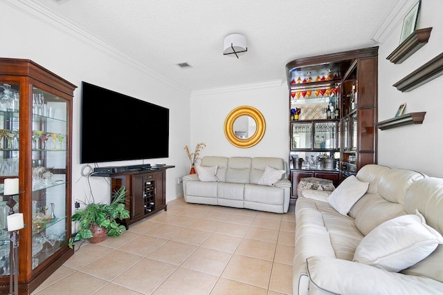 living room featuring ornamental molding, light tile patterned floors, and a textured ceiling