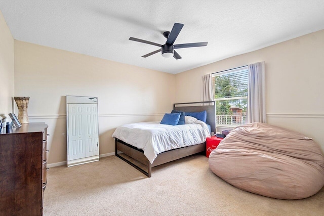 carpeted bedroom featuring a textured ceiling and ceiling fan