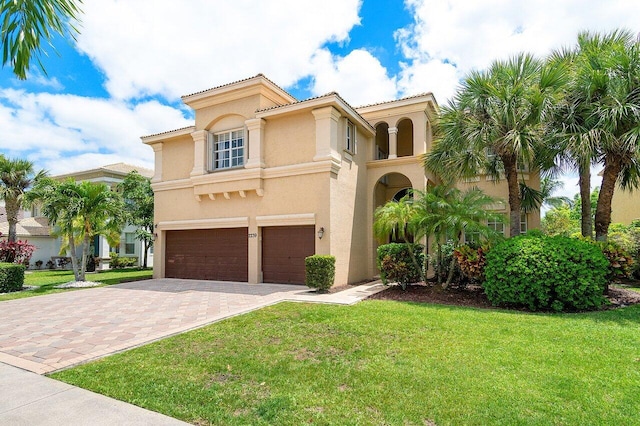 mediterranean / spanish-style house with a front yard and a garage