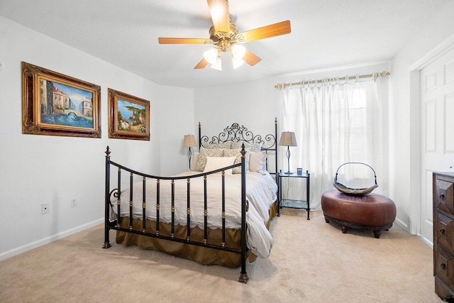 bedroom featuring light colored carpet and ceiling fan