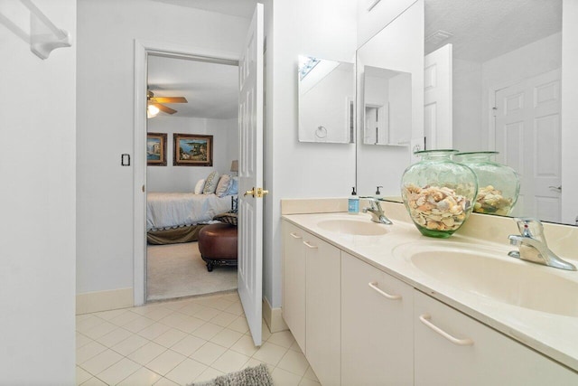 bathroom featuring ceiling fan, tile patterned flooring, vanity, and a textured ceiling