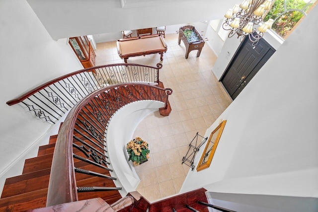 stairway featuring an inviting chandelier