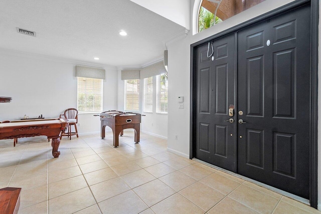 recreation room with ornamental molding, pool table, and light tile patterned floors