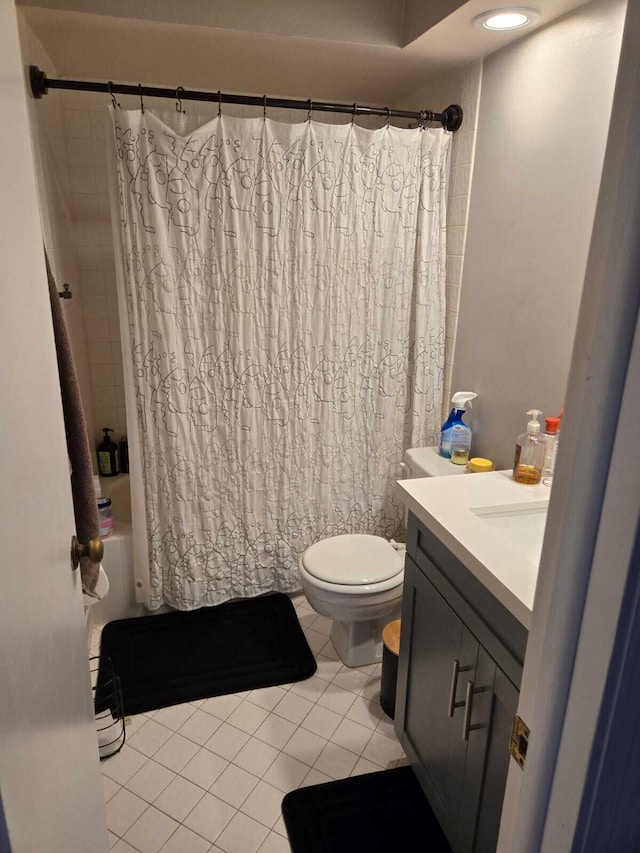 full bathroom with vanity, shower / tub combo with curtain, toilet, and tile patterned floors