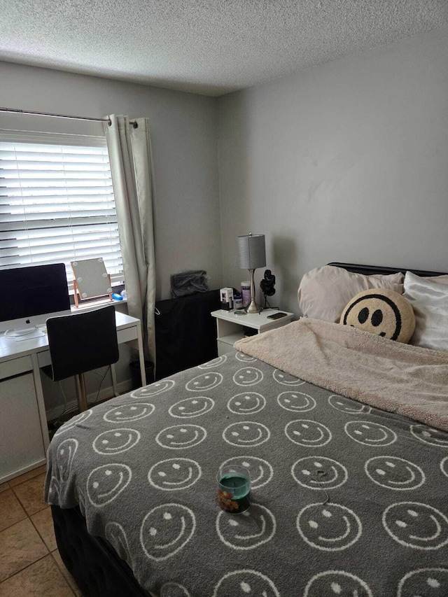 tiled bedroom with a textured ceiling