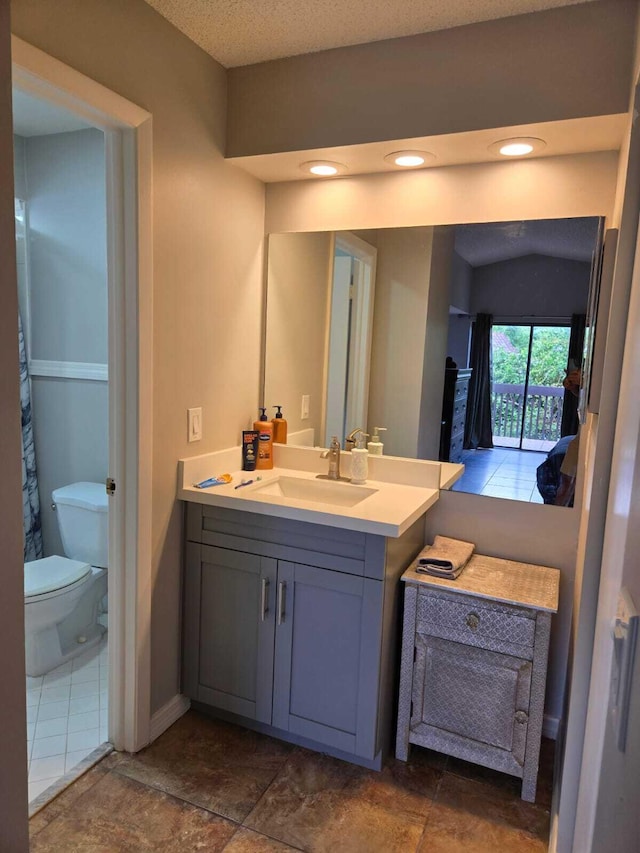 bathroom featuring toilet and vanity