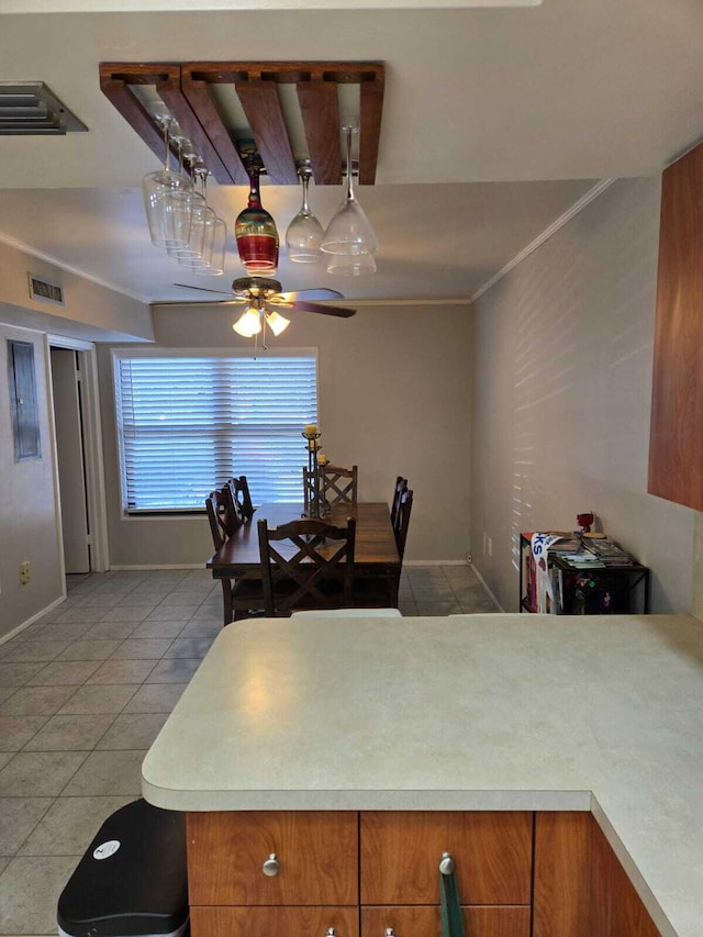 kitchen with ceiling fan, ornamental molding, and tile patterned flooring