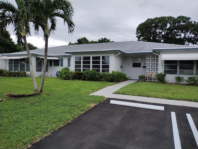 ranch-style home with a front lawn