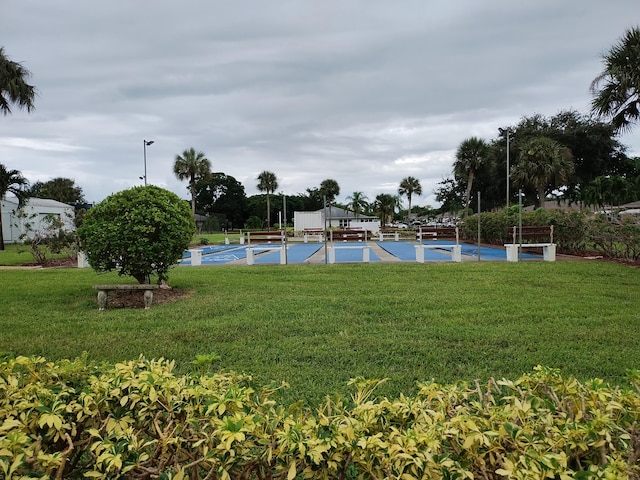 view of pool featuring a lawn