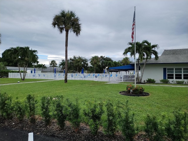 view of community with a yard and a swimming pool