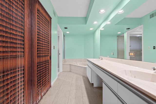 bathroom featuring a washtub, vanity, and tile patterned floors