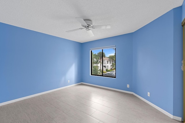 empty room featuring a textured ceiling and ceiling fan